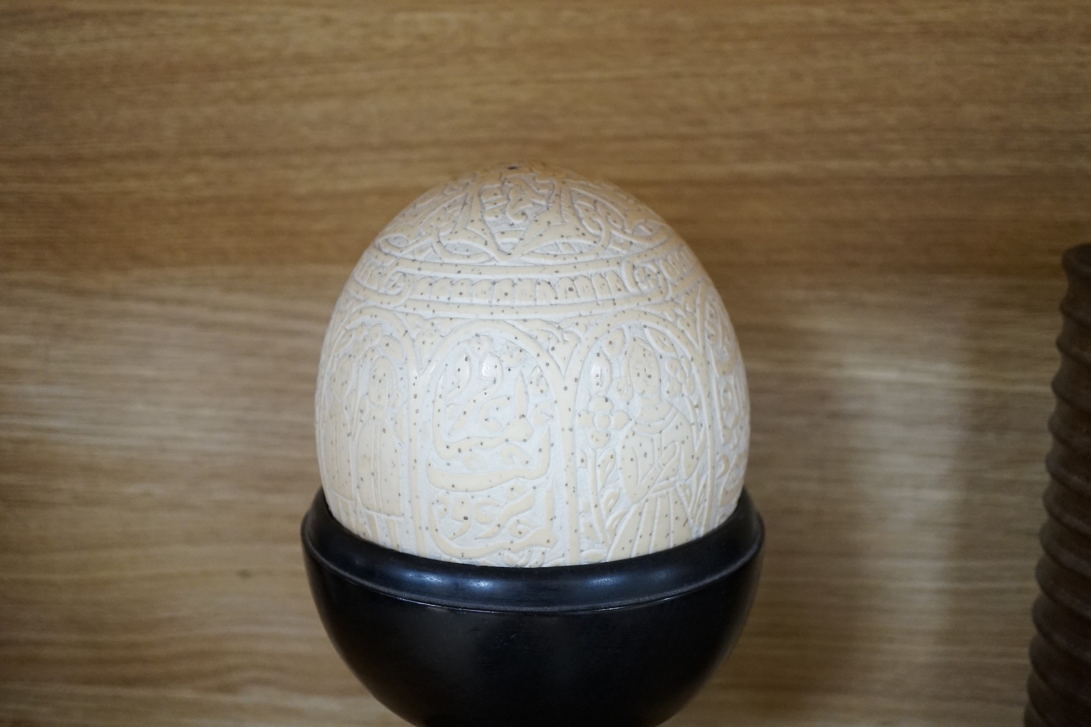 A quantity of African and other carvings including an ostrich egg